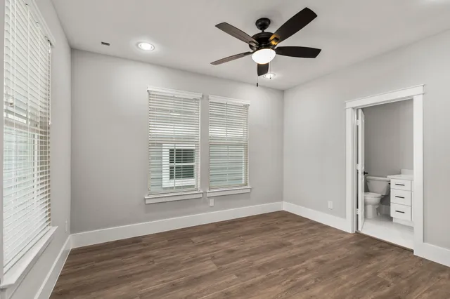 a bathroom with a bathtub shower sink vanity and toilet