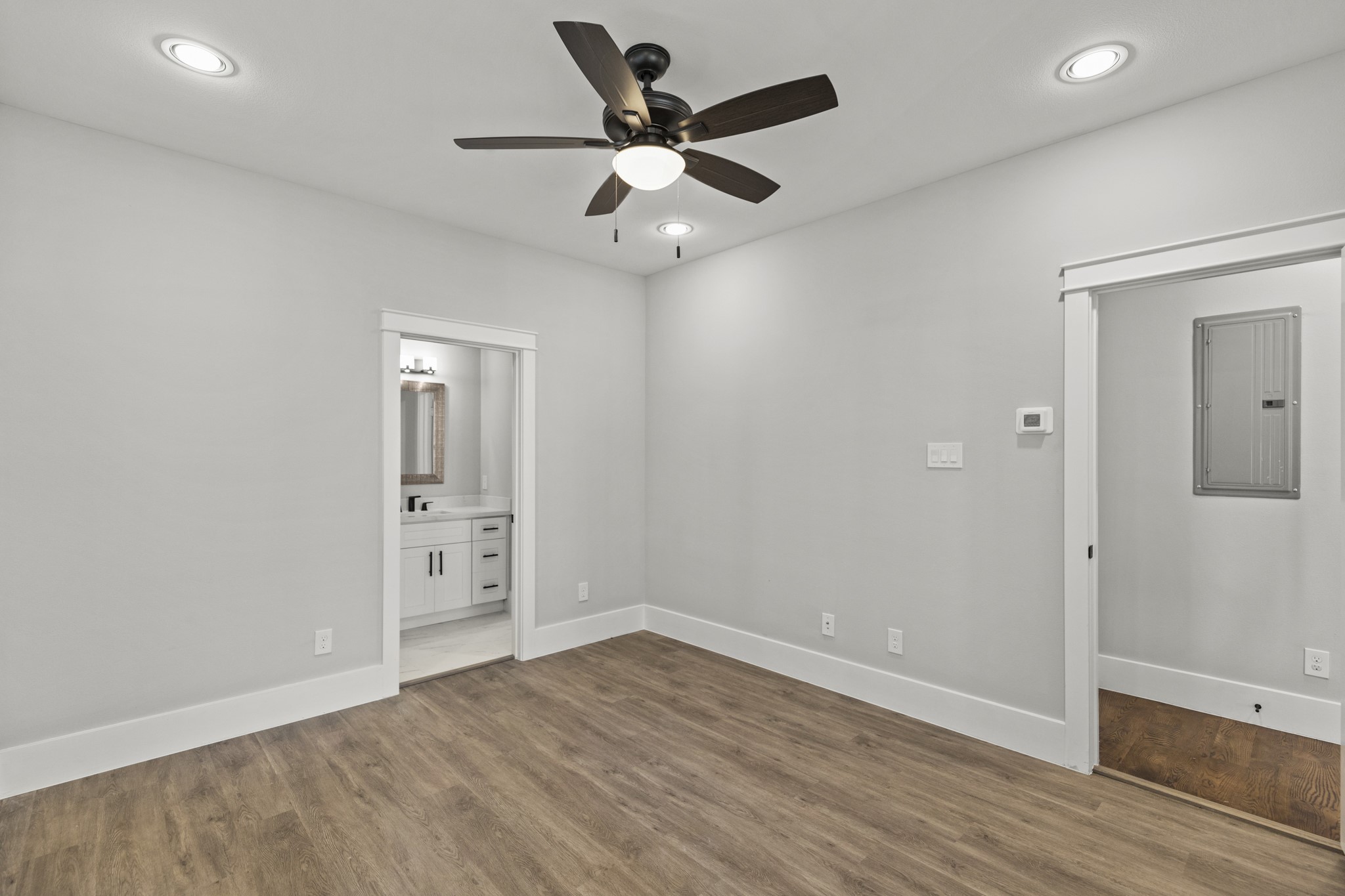 1421 West 23rd Street, Unit C Houston, TX 77008 - Photo 26 of 40 an empty room with wooden floor and ceiling fan
