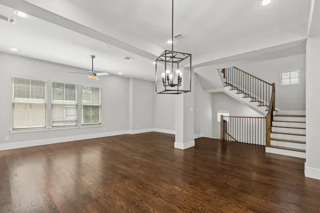 a view of empty room with wooden floor fireplace and entryway