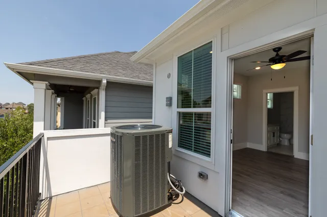 a view of staircase with railing and white walls