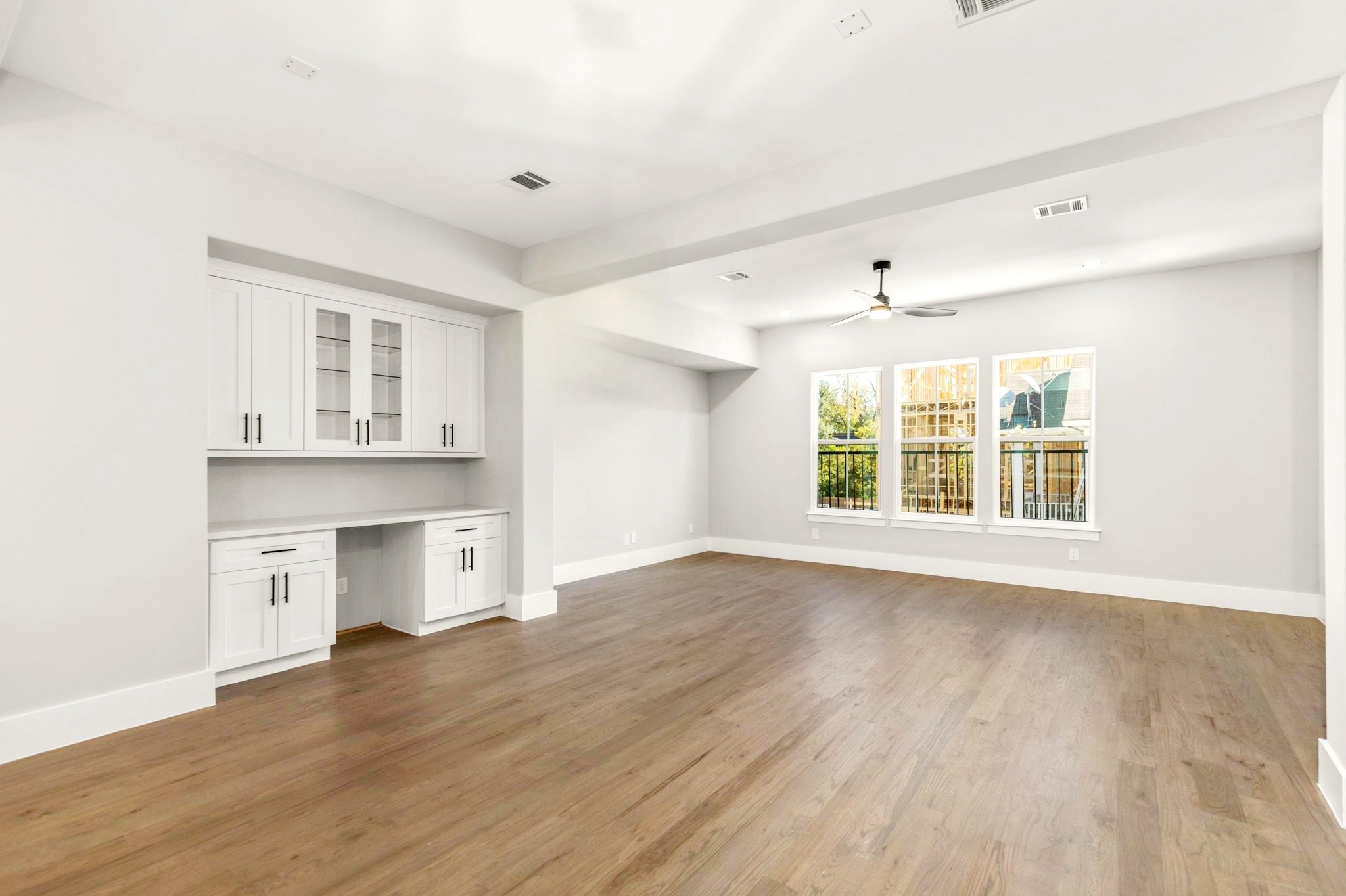 1421 West 23rd Street, Unit C Houston, TX 77008 - Photo 4 of 40 a view of an empty room with a window and wooden floor