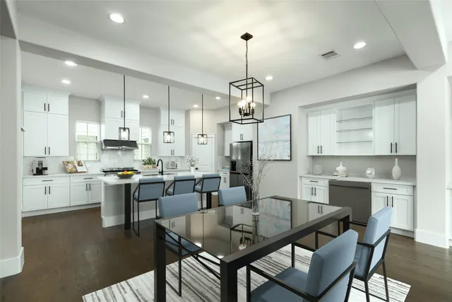 a large kitchen with a table and chairs