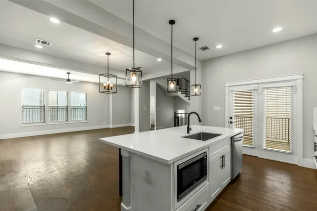a kitchen with stainless steel appliances granite countertop a sink and a refrigerator