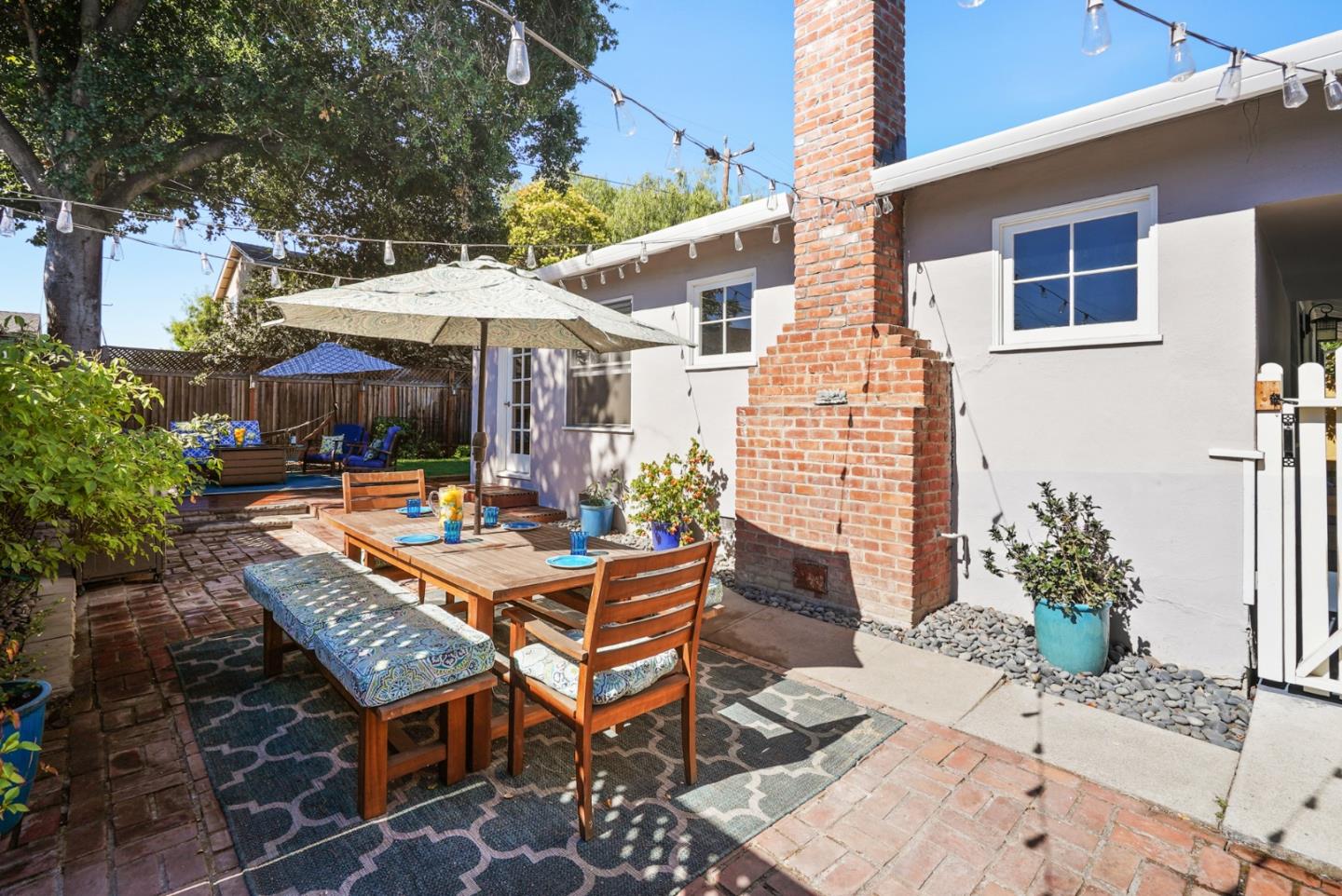 2250 Tulip Road San Jose, CA 95128 - Photo 21 of 39 a view of a patio with a table and chairs under an umbrella