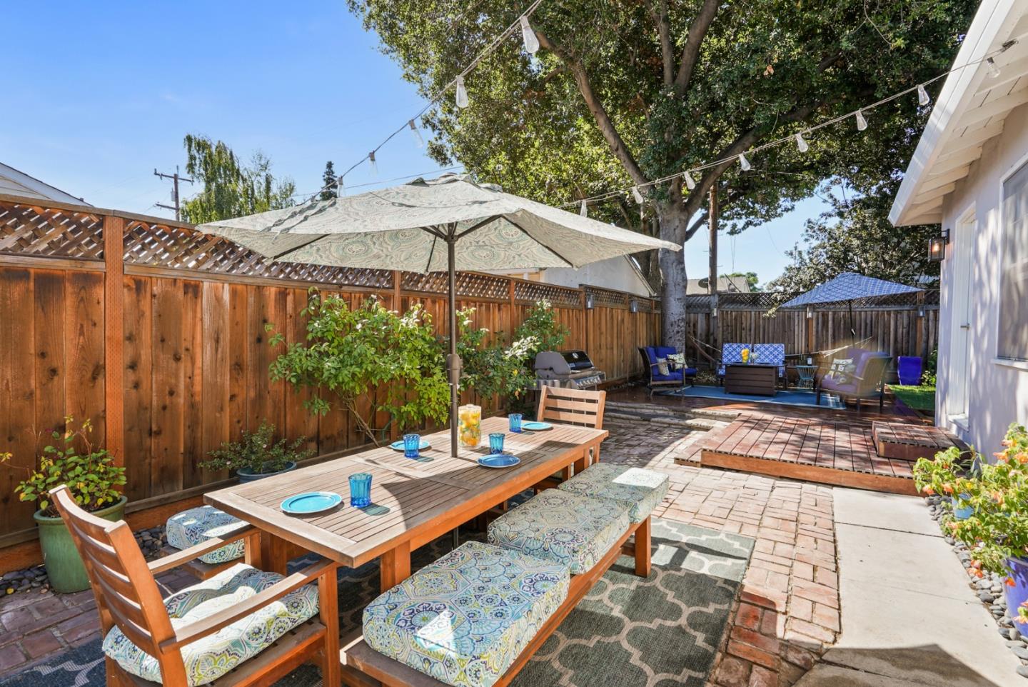 2250 Tulip Road San Jose, CA 95128 - Photo 22 of 39 a view of a patio with a table and chairs under an umbrella