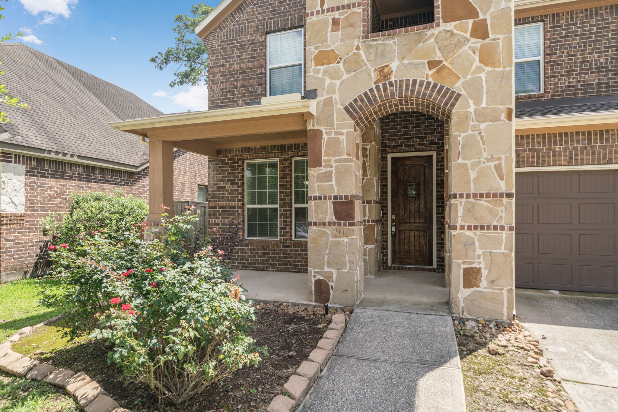 22523 Birch Ridge Meadow Drive Spring, TX 77389 - Photo 2 of 39 a front view of a building with garden