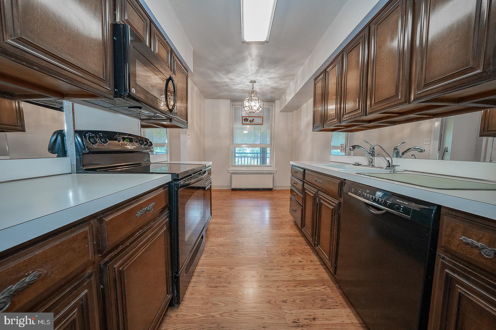 41 Conshohocken State Road, Unit 203 Bala Cynwyd, PA 19004 - Photo 10 of 34 Wood Tone Cabinetry with White Counters
