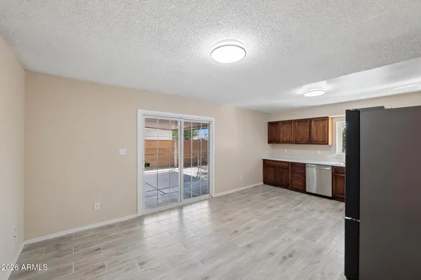 a kitchen with stainless steel appliances a refrigerator and wooden cabinets