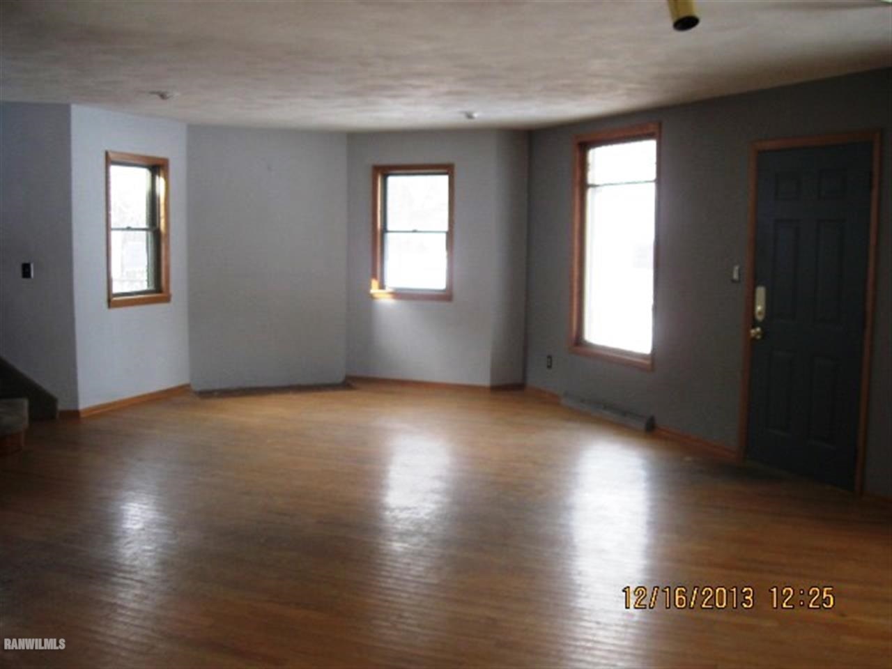 1471 West Becker School Road Freeport, IL 61032 - Photo 4 of 21 an empty room with wooden floor and windows