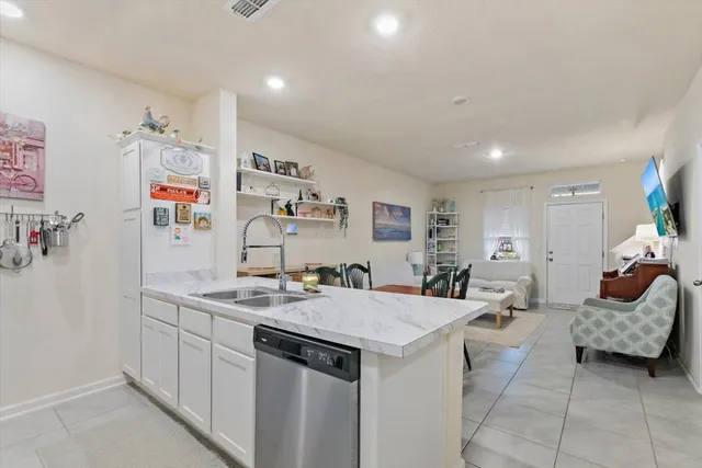 a view of a very nice looking dining room with a table and chairs