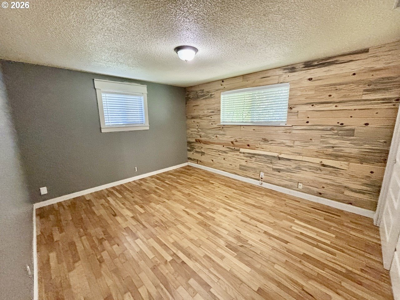 38684 Natures Garden Street Springfield, OR 97478 - Photo 15 of 26 a view of a bedroom with wooden floor and cabinet
