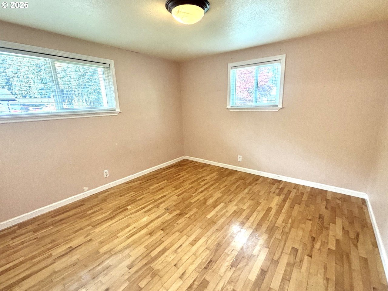 38684 Natures Garden Street Springfield, OR 97478 - Photo 17 of 26 a view of an empty room with wooden floor and a window