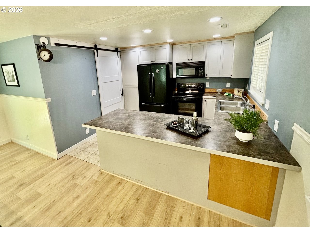 38684 Natures Garden Street Springfield, OR 97478 - Photo 4 of 26 a kitchen with a sink stainless steel appliances a counter top space and cabinets