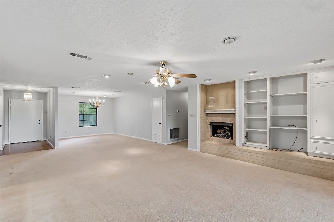 807 Standley Road Madisonville, TX 77864 - Photo 13 of 35 a view of an empty room with a fireplace and a window