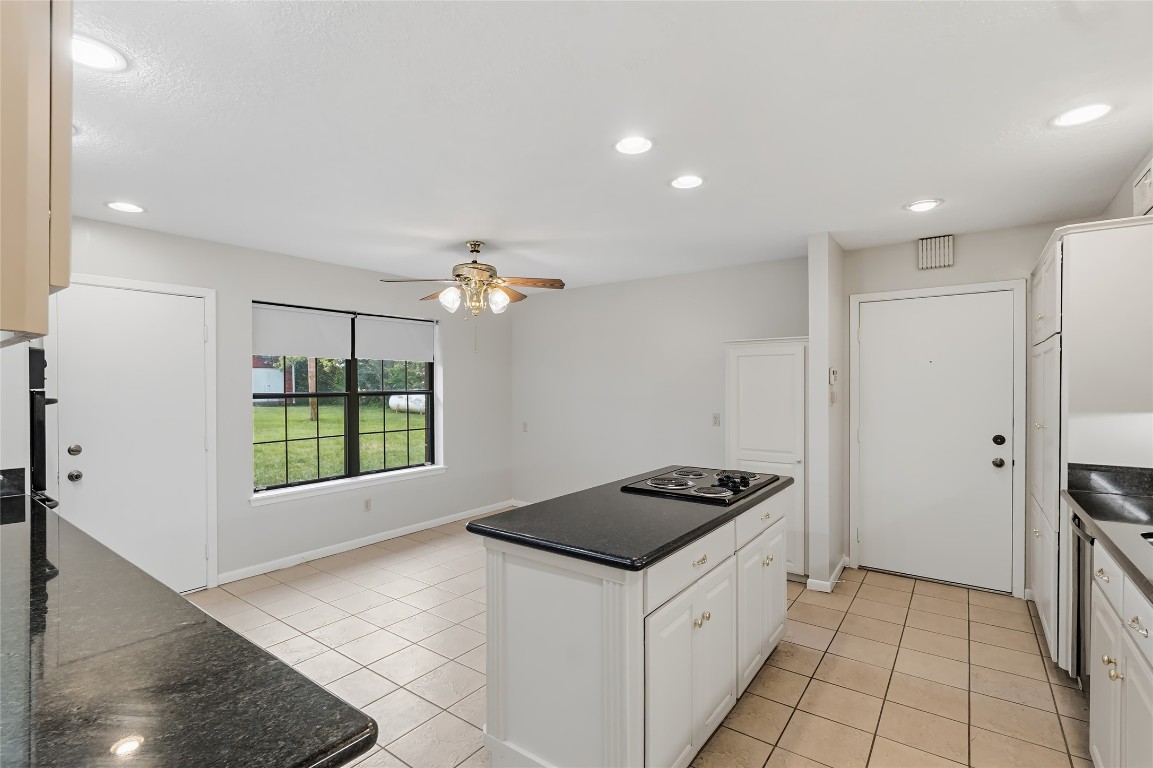807 Standley Road Madisonville, TX 77864 - Photo 16 of 35 a kitchen with a refrigerator and a stove top oven