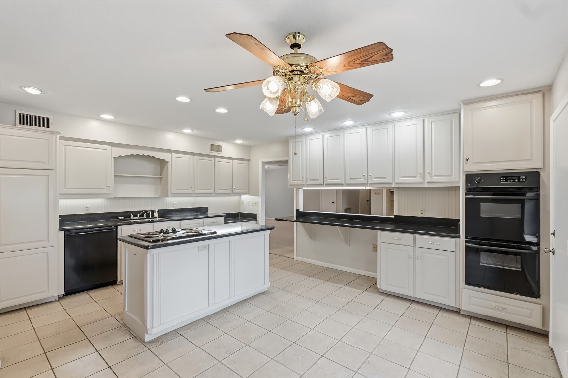 807 Standley Road Madisonville, TX 77864 - Photo 19 of 35 a kitchen with stainless steel appliances granite countertop a stove and a refrigerator