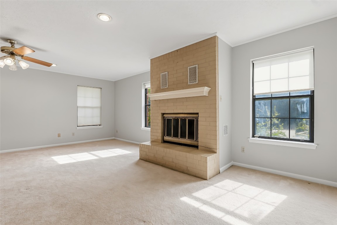807 Standley Road Madisonville, TX 77864 - Photo 28 of 35 an empty room with windows and fireplace