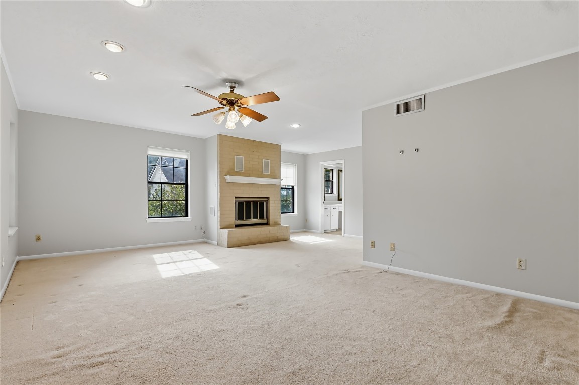 807 Standley Road Madisonville, TX 77864 - Photo 29 of 35 an empty room with windows and fireplace