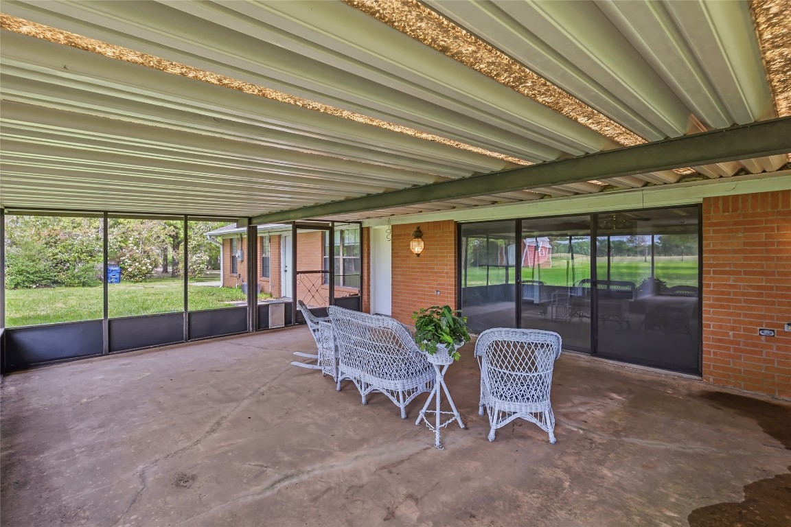 807 Standley Road Madisonville, TX 77864 - Photo 32 of 35 a view of a porch with chairs and backyard