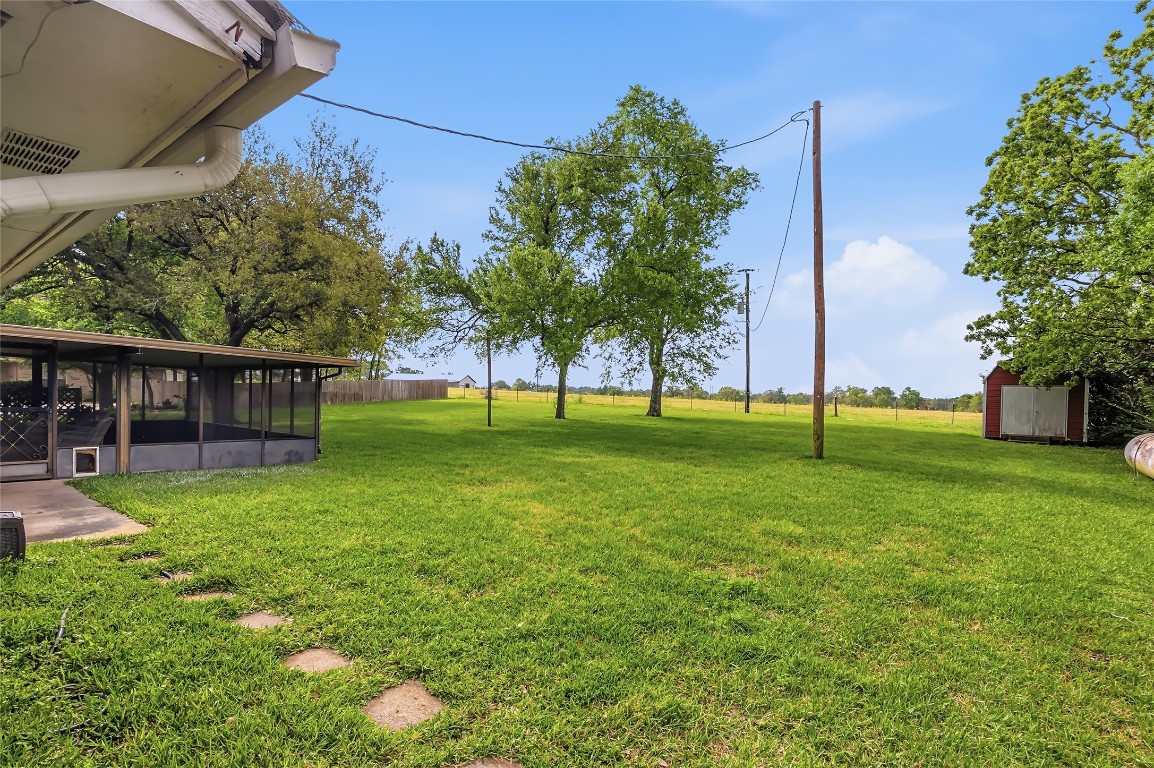 807 Standley Road Madisonville, TX 77864 - Photo 33 of 35 a view of a house with a backyard