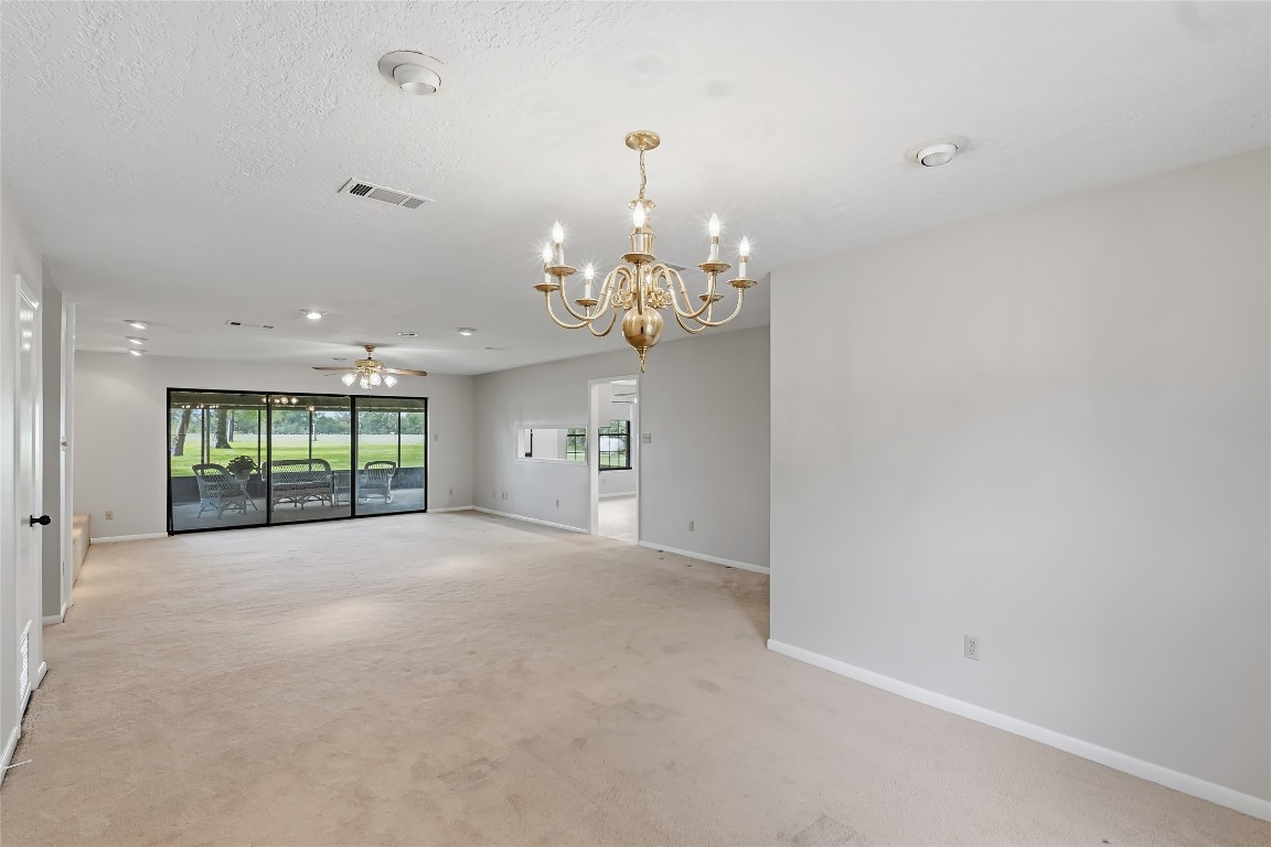 807 Standley Road Madisonville, TX 77864 - Photo 10 of 35 a view of a big room with windows and chandelier