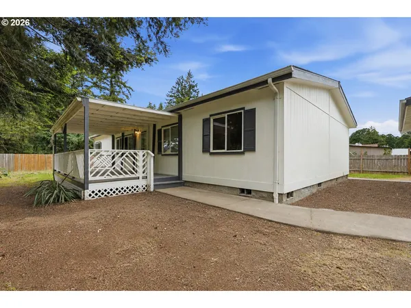 a view of a house with a yard and garage