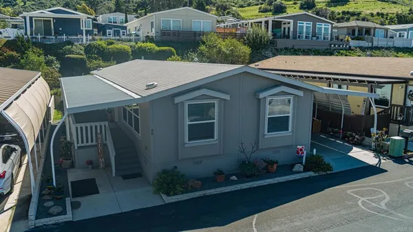 a aerial view of a house with yard and tree s