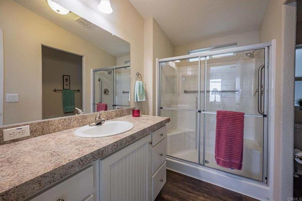 4650 Dulin Road, Unit 40 Fallbrook, CA 92003 - Photo 28 of 52 a bathroom with a granite countertop shower sink and mirror