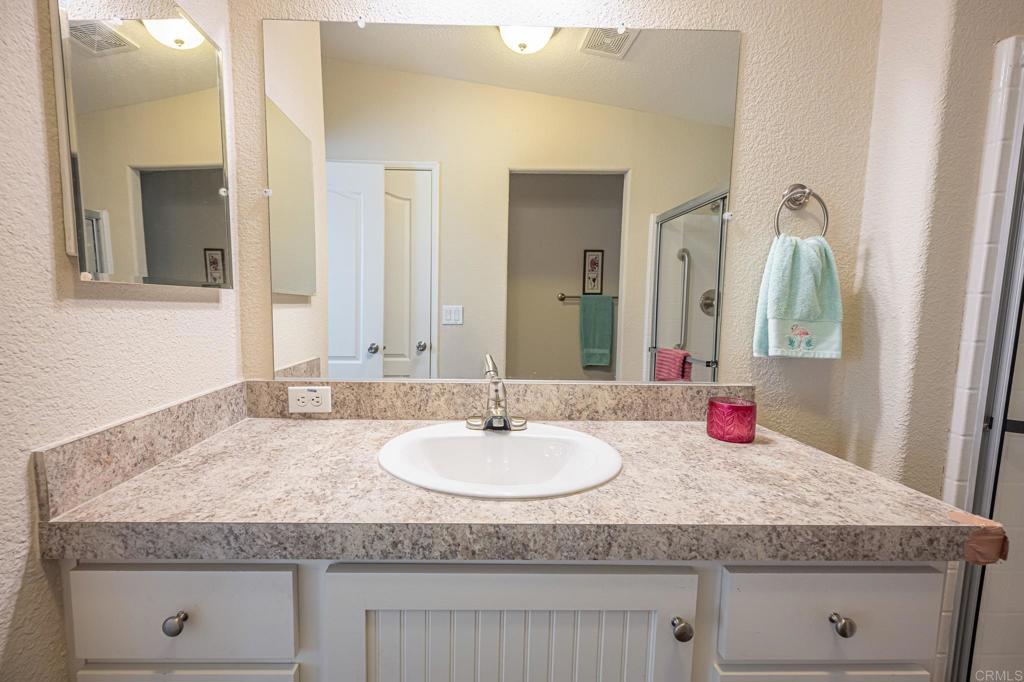4650 Dulin Road, Unit 40 Fallbrook, CA 92003 - Photo 29 of 52 a bathroom with a granite countertop sink and a mirror