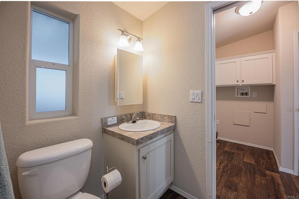 4650 Dulin Road, Unit 40 Fallbrook, CA 92003 - Photo 32 of 52 a bathroom with a toilet sink and mirror