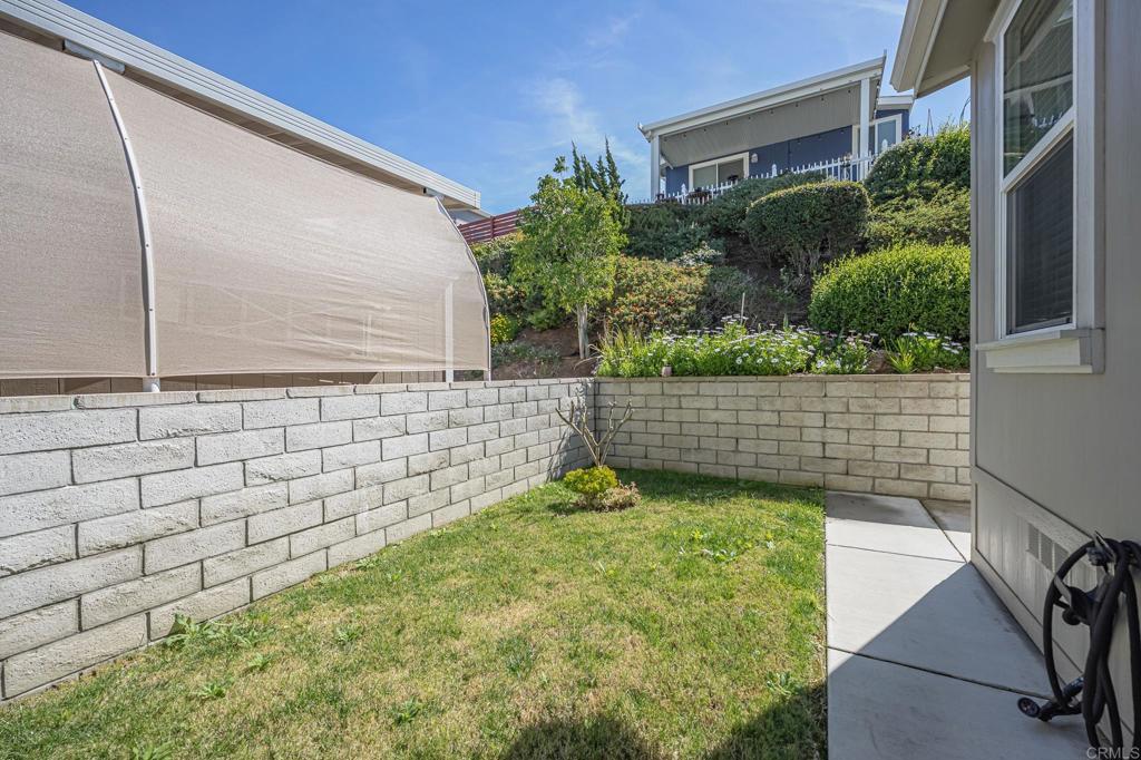 4650 Dulin Road, Unit 40 Fallbrook, CA 92003 - Photo 37 of 52 a backyard of a house with lots of green space