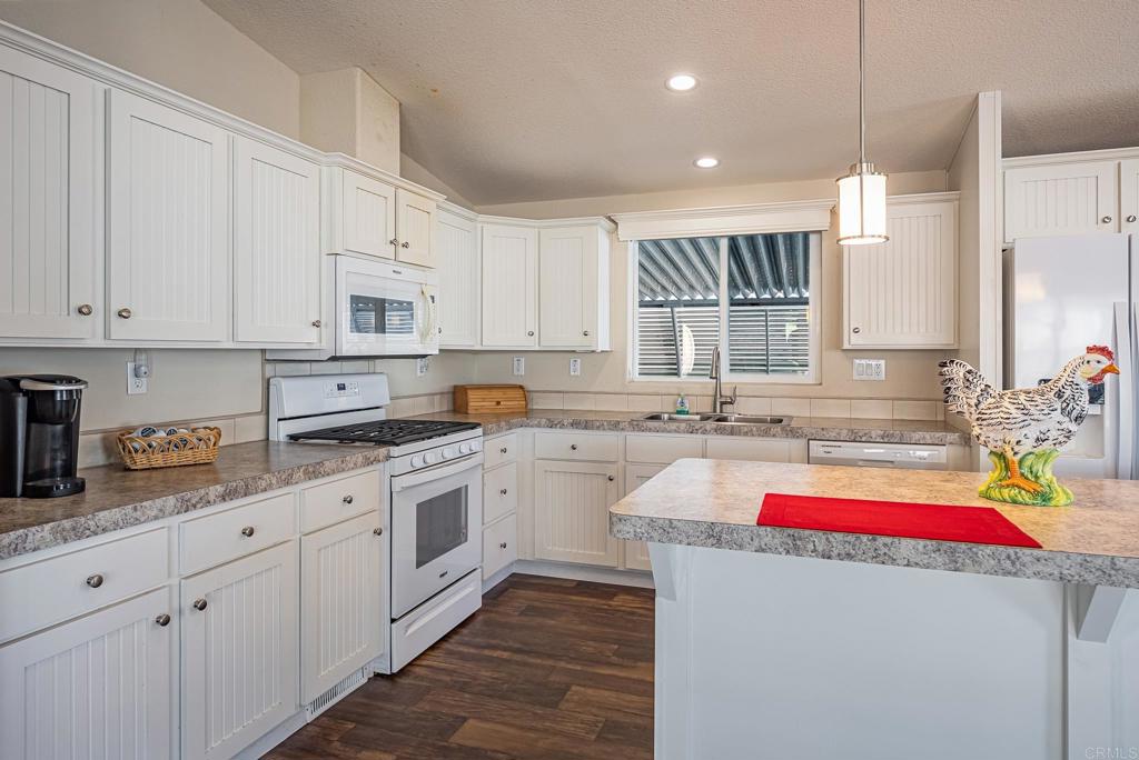 4650 Dulin Road, Unit 40 Fallbrook, CA 92003 - Photo 8 of 52 a kitchen that has a lot of cabinets in it and wooden floor