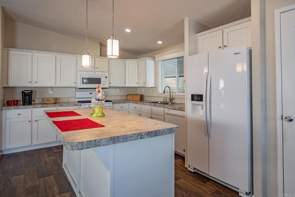 4650 Dulin Road, Unit 40 Fallbrook, CA 92003 - Photo 9 of 52 a kitchen with refrigerator cabinets and wooden floor