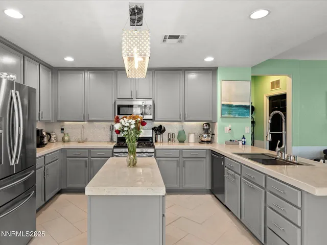 a kitchen with a sink stainless steel appliances and cabinets