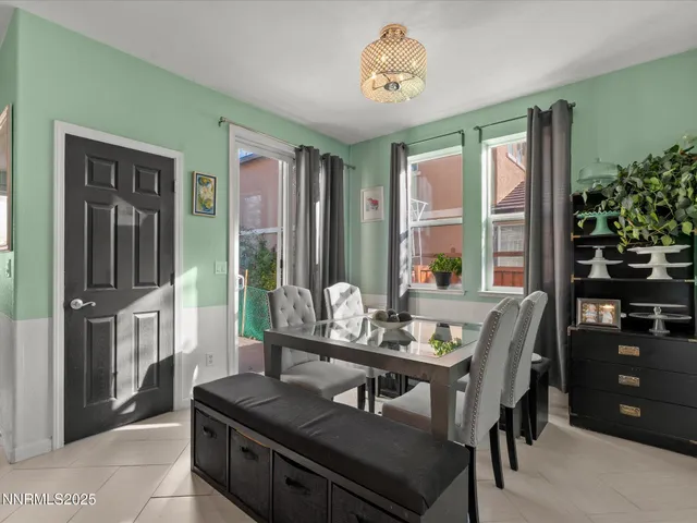 a living room with furniture fireplace and a large window