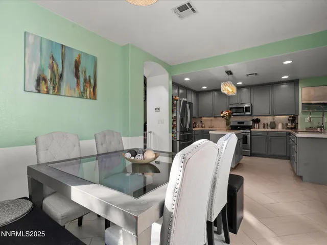 a living room with furniture kitchen view and a table