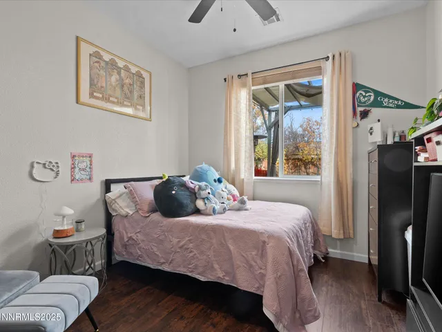 a bedroom with a bed couch and a window