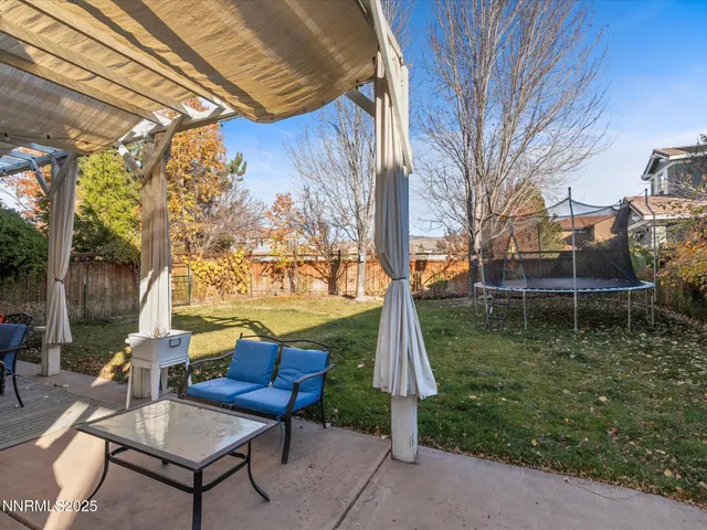 a backyard of a house with table and chairs