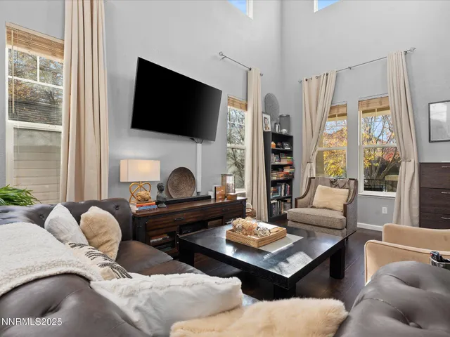 a living room with fireplace furniture and a flat screen tv