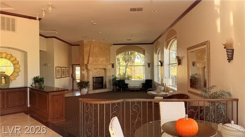 2050 West Warm Springs Road, Unit 2422 Henderson, NV 89014 - Photo 38 of 44 This inviting living space features an elegant fireplace and bright arched windows, perfect for comfortable gatherings.