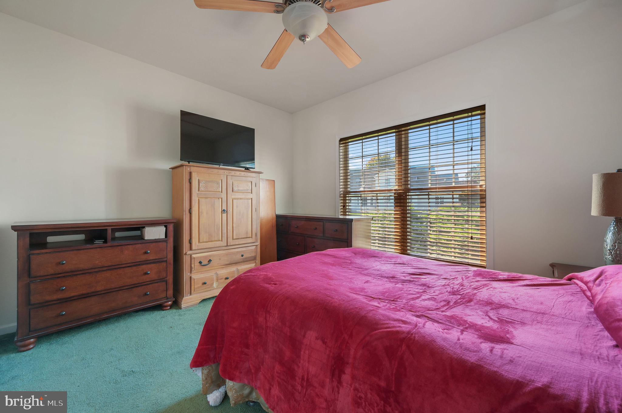 85 Redcrest Court Dover, DE 19904 - Photo 16 of 20 a bedroom with a bed and a flat tv screen tv