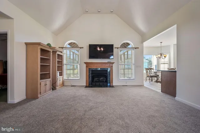 a view of a livingroom with a fireplace and window