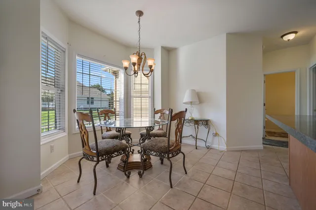 a view of a dining room with furniture and window