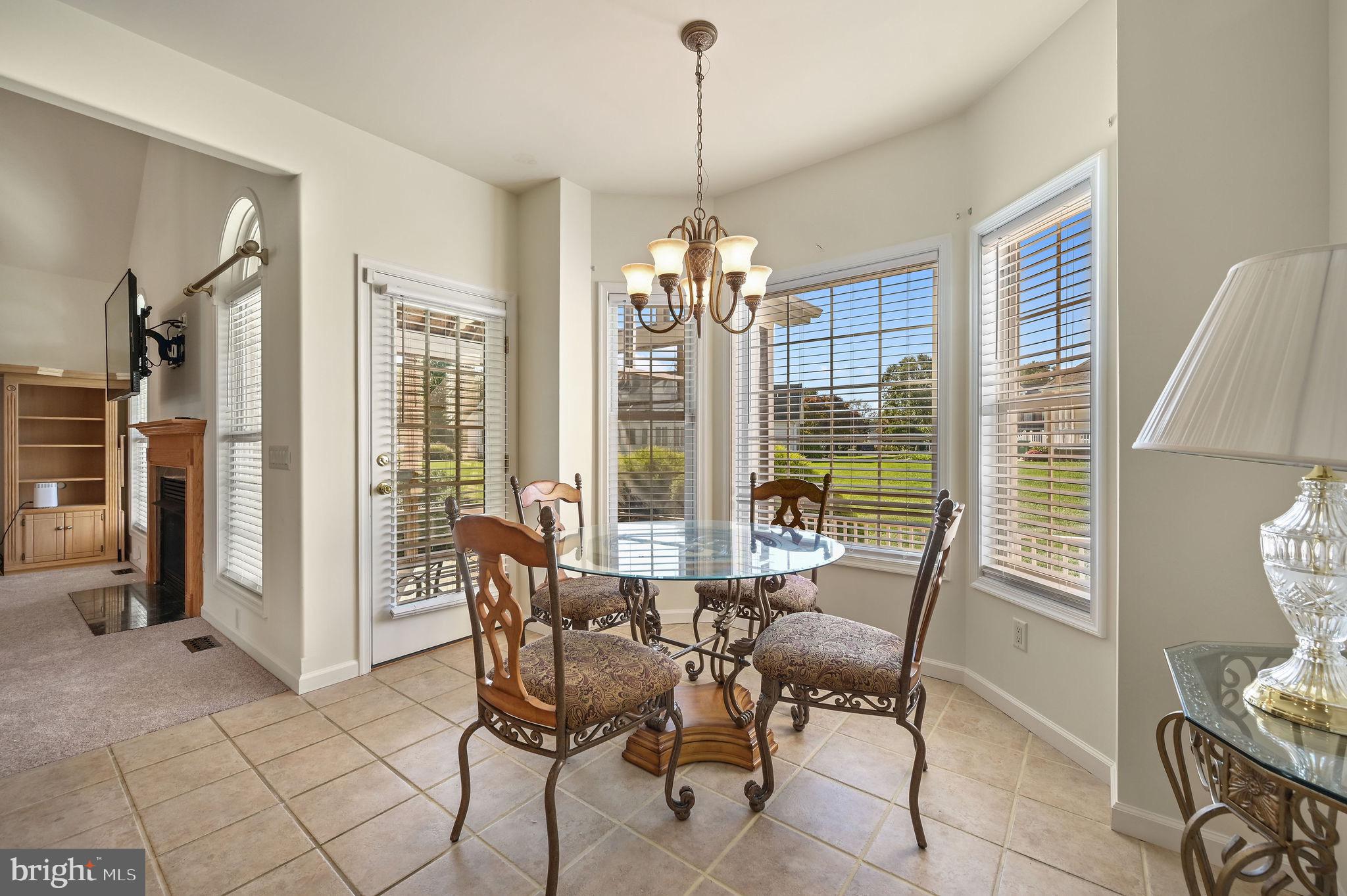85 Redcrest Court Dover, DE 19904 - Photo 9 of 20 a dining room with furniture a chandelier and wooden floor