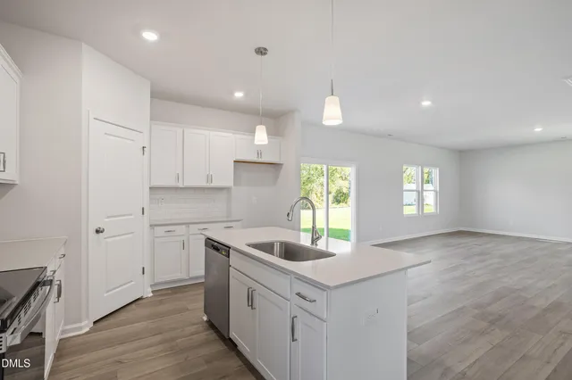a kitchen with sink cabinets and window