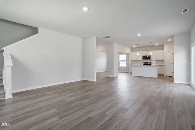 a view of kitchen with cabinets and wooden floor
