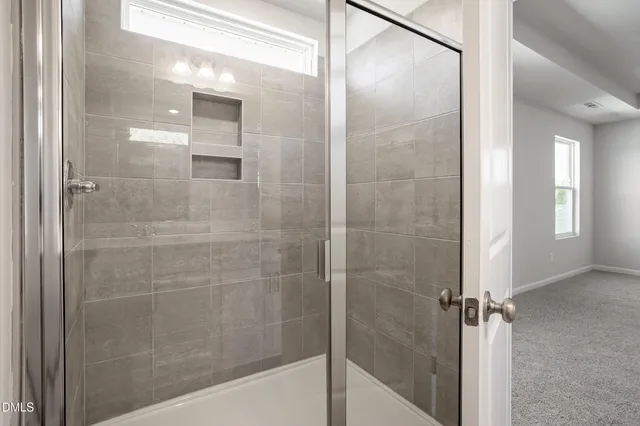 a bathroom with a glass shower door