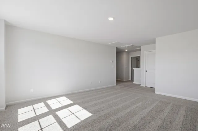 a view of an empty room and a window