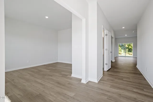 a view of a hallway with wooden floor