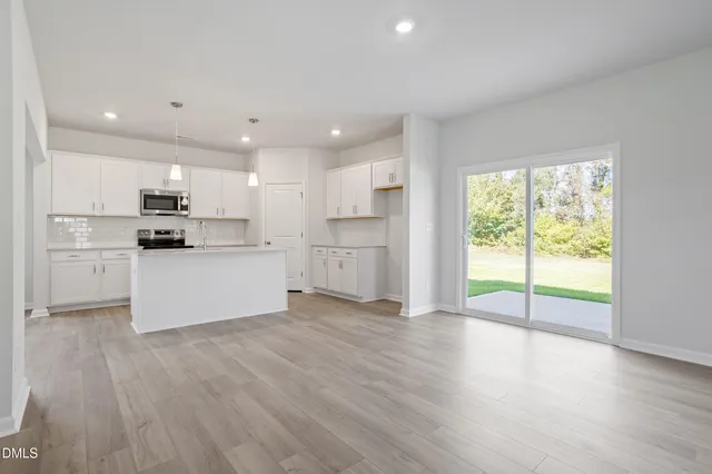 a view of kitchen with wooden floor and electronic appliances